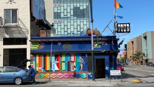 Exterior shot of the stud bar in San Francisco, CA. Image captured in June of 2020 during the COVID pandemic while San Francisco was still shutdown. The exterior of the building is covered in graffiti and murals by various queer artists.