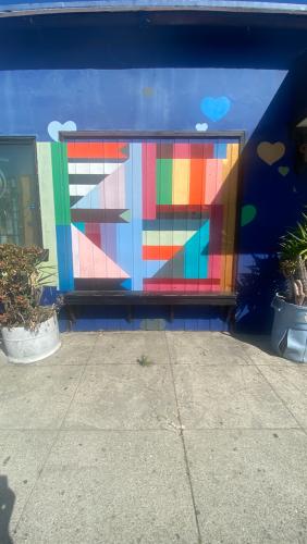 Exterior shot of the stud bar in San Francisco, CA. Image captured in June of 2020 during the COVID pandemic while San Francisco was still shutdown. The exterior of the building is covered in graffiti and murals by various queer artists.