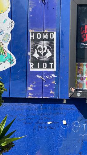 Exterior shot of the stud bar in San Francisco, CA. Image captured in June of 2020 during the COVID pandemic while San Francisco was still shutdown. The exterior of the building is covered in graffiti and murals by various queer artists.