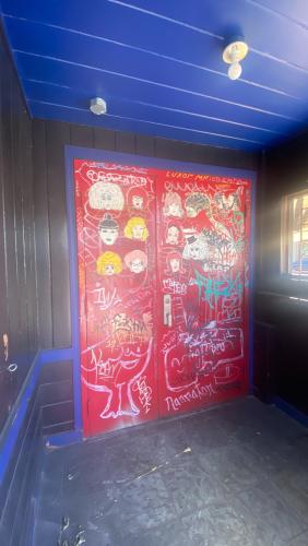 Exterior shot of the stud bar in San Francisco, CA. Image captured in June of 2020 during the COVID pandemic while San Francisco was still shutdown. The exterior of the building is covered in graffiti and murals by various queer artists.
