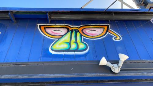 Exterior shot of the stud bar in San Francisco, CA. Image captured in June of 2020 during the COVID pandemic while San Francisco was still shutdown. The exterior of the building is covered in graffiti and murals by various queer artists.